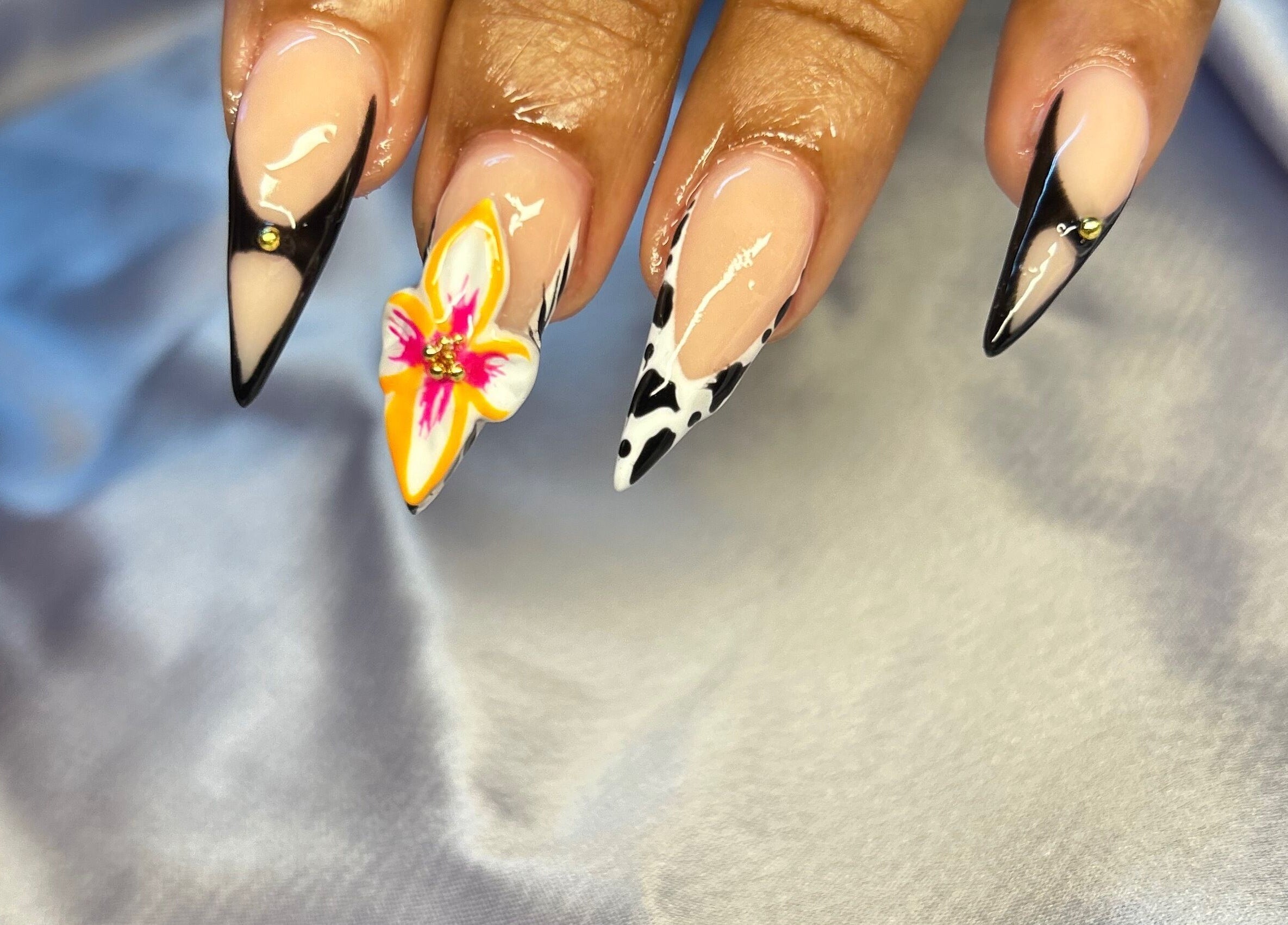 Intricate nail art at TNP Salon, Nassau, New Providence, BS displaying elegant floral and geometric designs.