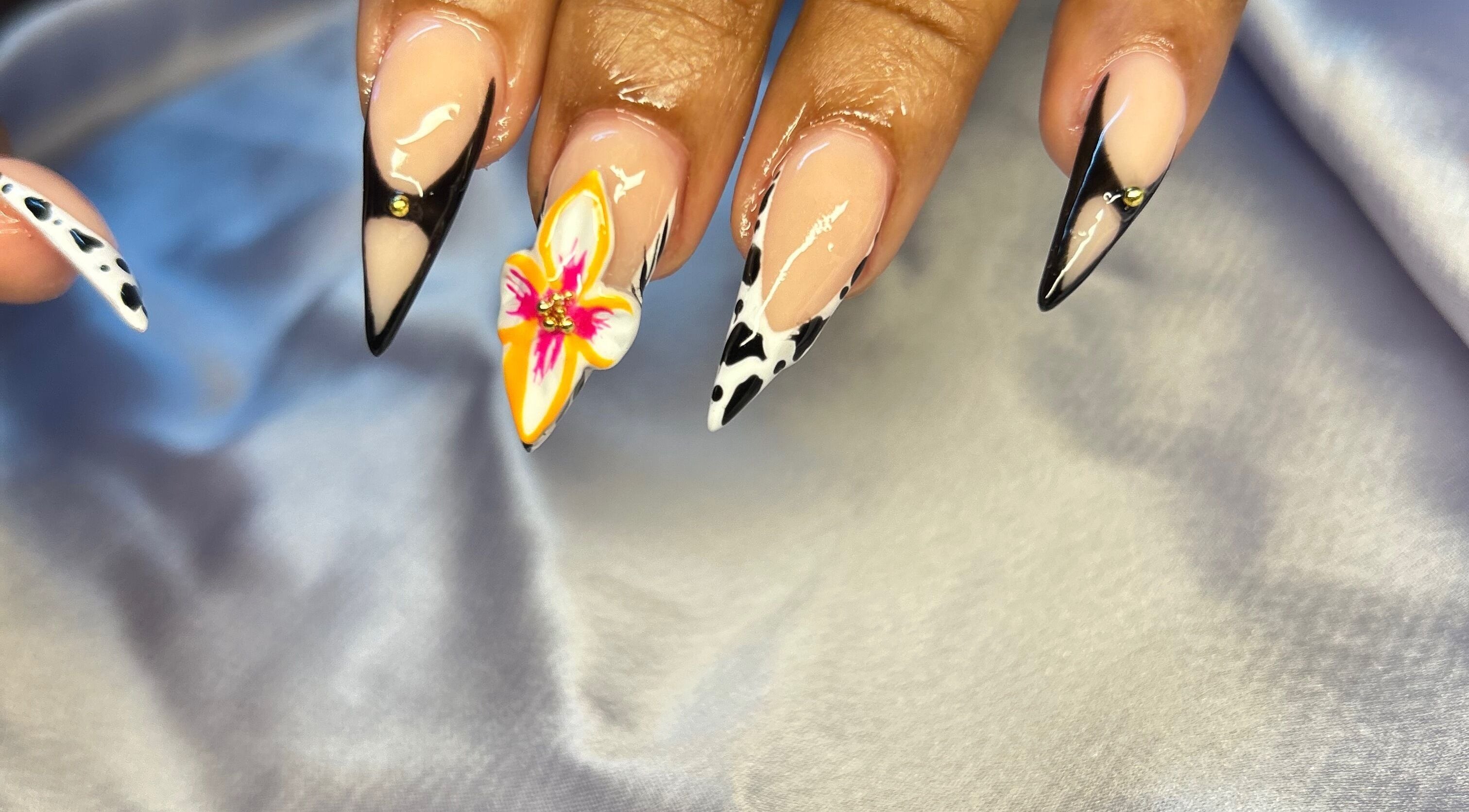 Intricate nail art at TNP Salon, Nassau, New Providence, BS displaying elegant floral and geometric designs.