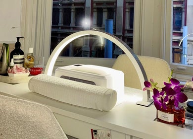 Elegant nail station at Q Nails & Design Sydney, featuring products and orchids in Sydney, New South Wales, AU.