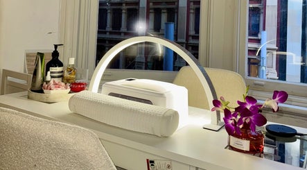 Elegant nail station at Q Nails & Design Sydney, featuring products and orchids in Sydney, New South Wales, AU.