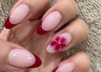 Red flower nail art with elegant French tips at Q Nails & Design Sydney, New South Wales, AU.