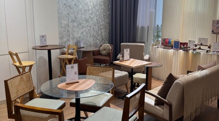 Relaxing seating area at Velveté Boutique in Singapore, SG featuring cozy chairs and modern decor.