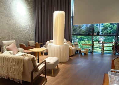 Elegant lounge area in Velveté Boutique, Singapore, SG, with cozy seating and abundant natural light.