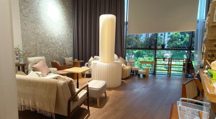 Elegant lounge area in Velveté Boutique, Singapore, SG, with cozy seating and abundant natural light.