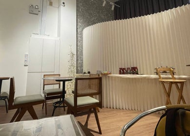 Relaxing seating area at Velveté Boutique in Singapore, Singapore, SG with modern decor and neutral tones.