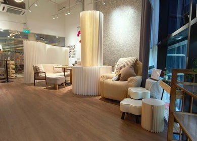 Relaxing lounge area in Velveté Boutique, Singapore, SG with elegant decor and plush seating.