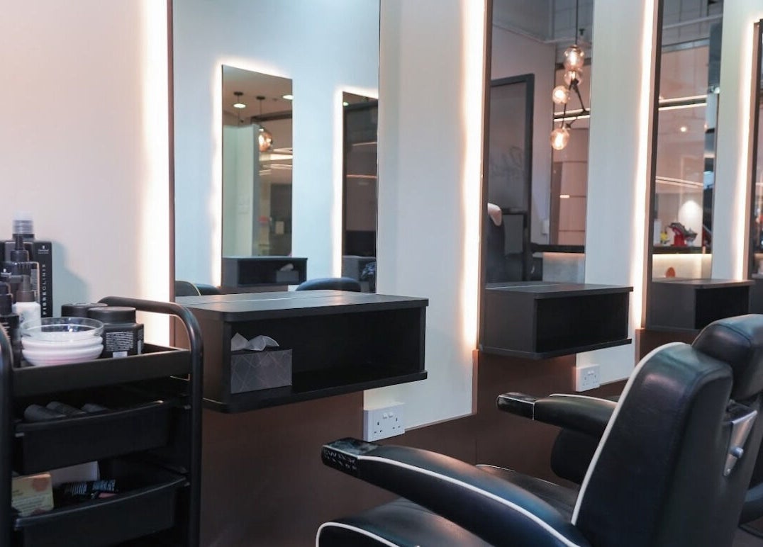 Spacious, modern salon at Perfect Style Salon, Singapore, SG with sleek black chairs and illuminated mirrors.
