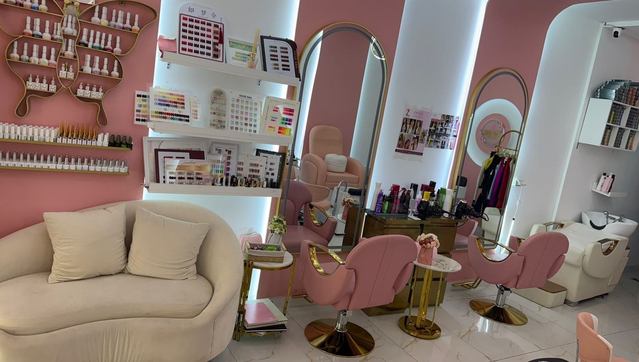 Chic pink-themed interior of Zap Luxy Beauty Salon, Dubai, Dubai, AE, showcasing manicure stations and decor.