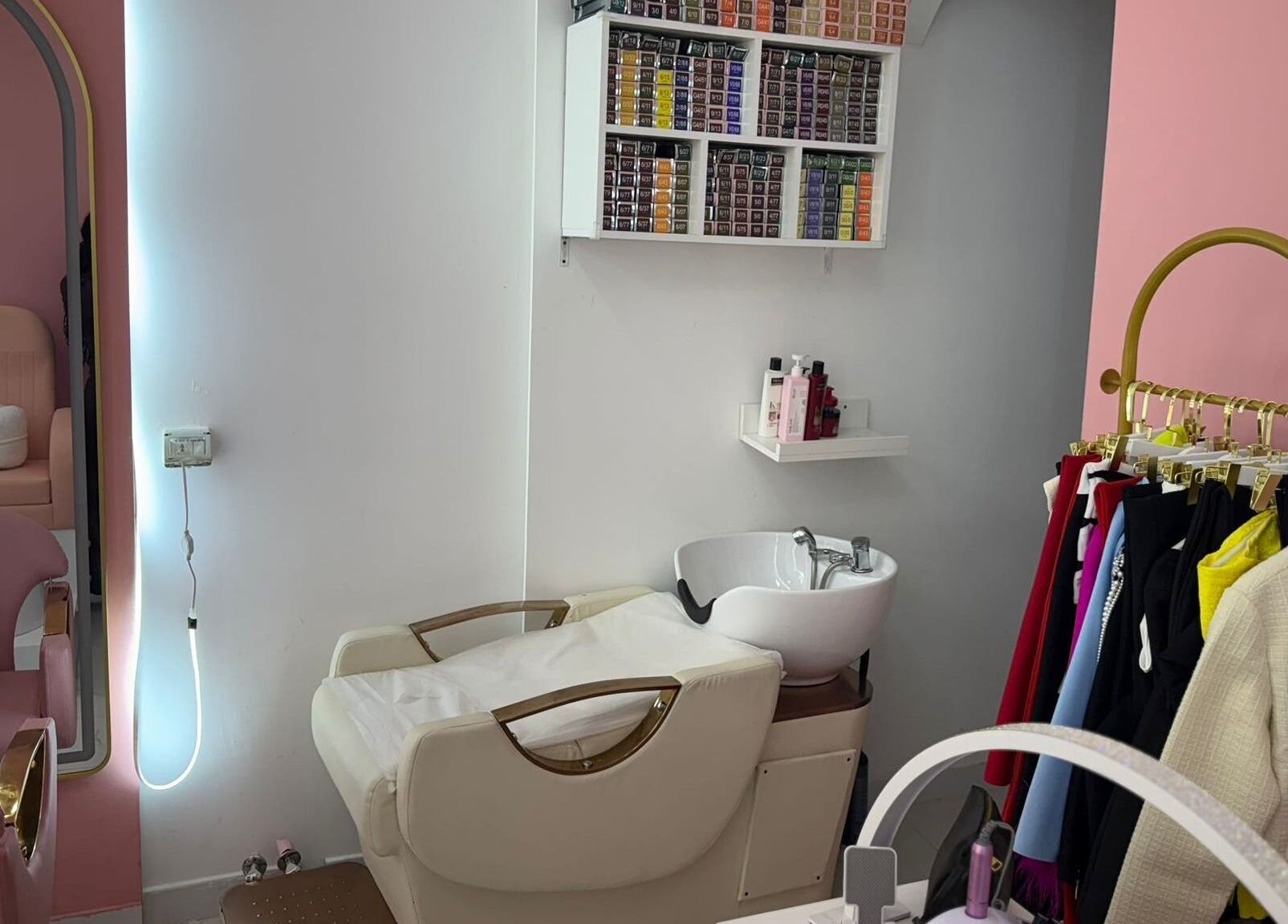 Cozy styling area at Zap Luxy Beauty Salon in Dubai, Dubai, AE with pink chairs and hair products.
