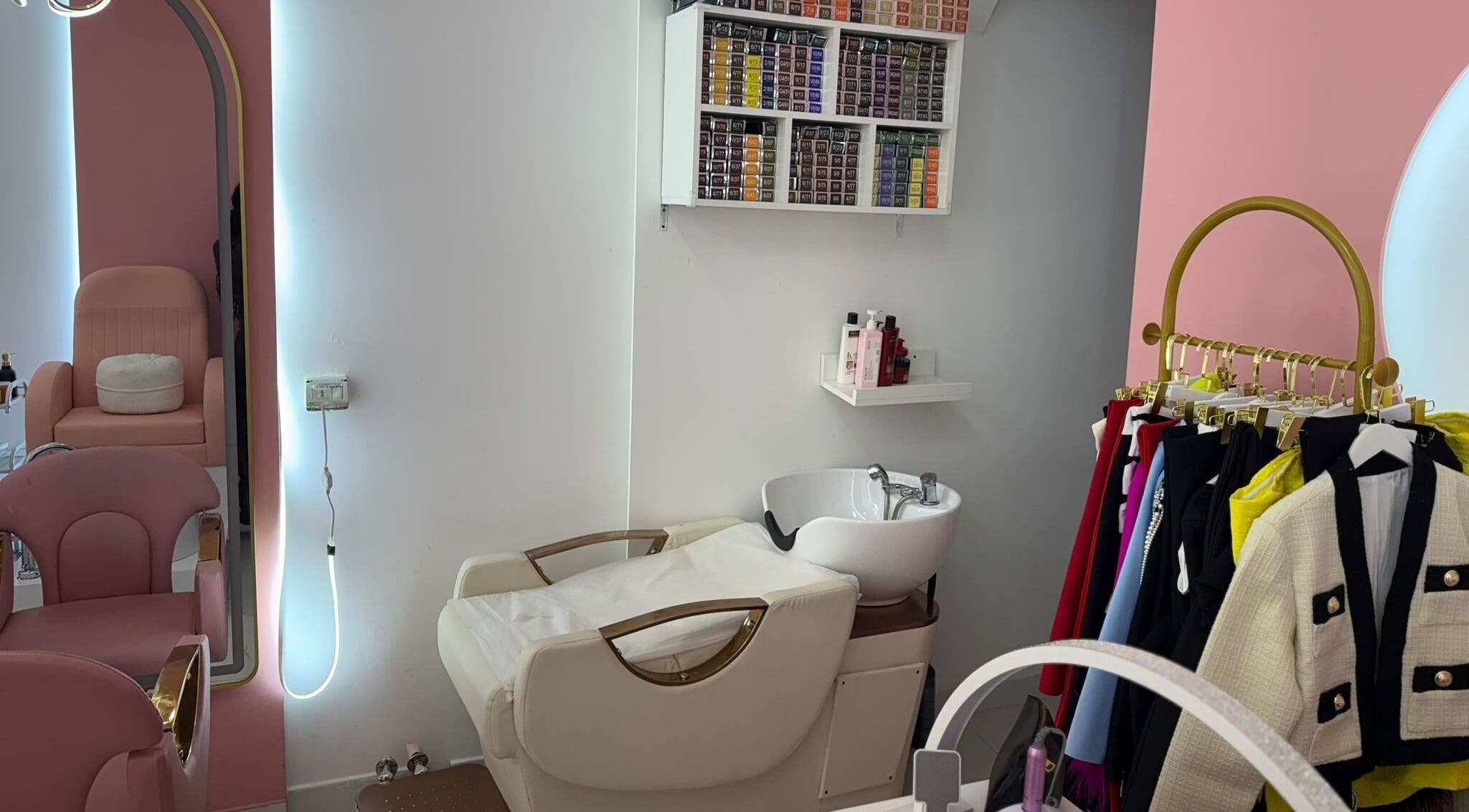 Cozy styling area at Zap Luxy Beauty Salon in Dubai, Dubai, AE with pink chairs and hair products.