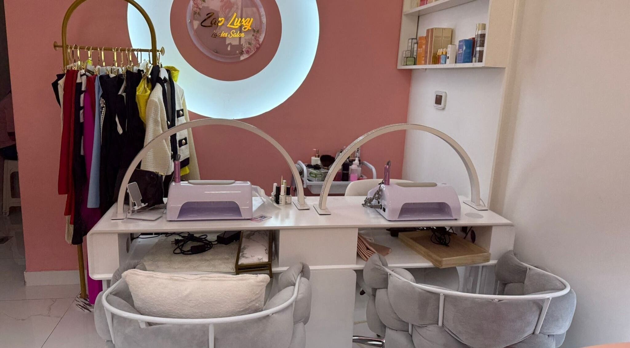Elegant nail station at Zap Luxy Beauty Salon in Dubai, Dubai, AE with stylish decor and plush seating.
