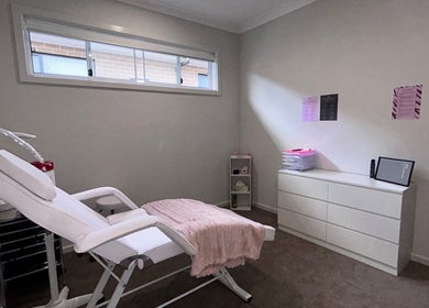 Calm treatment room at Brat Studio, Tahmoor, New South Wales, AU with a comfy chair and minimalist decor.