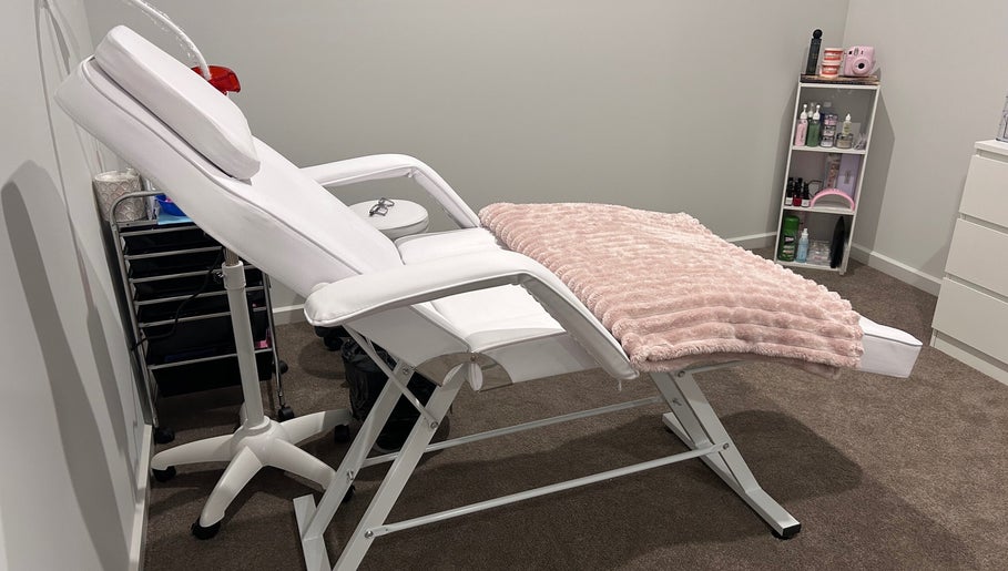 Luxury treatment chair at Brat Studio, Tahmoor, New South Wales, AU, with cozy pink throw and beauty products.