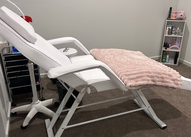 Luxury treatment chair at Brat Studio, Tahmoor, New South Wales, AU, with cozy pink throw and beauty products.