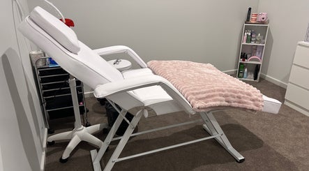 Luxury treatment chair at Brat Studio, Tahmoor, New South Wales, AU, with cozy pink throw and beauty products.