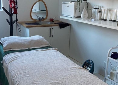 Tranquil treatment room at Mommy Wellness Day Spa Lansdowne, Cape Town, Western Cape, ZA, featuring massage bed.