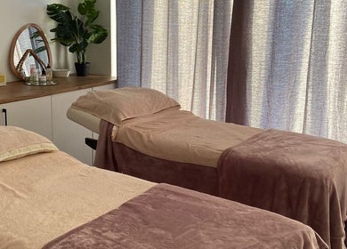 Relaxing treatment room at Mommy Wellness Day Spa Lansdowne, Cape Town, Western Cape, ZA with cozy massage beds.