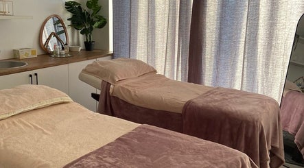 Relaxing treatment room at Mommy Wellness Day Spa Lansdowne, Cape Town, Western Cape, ZA with cozy massage beds.
