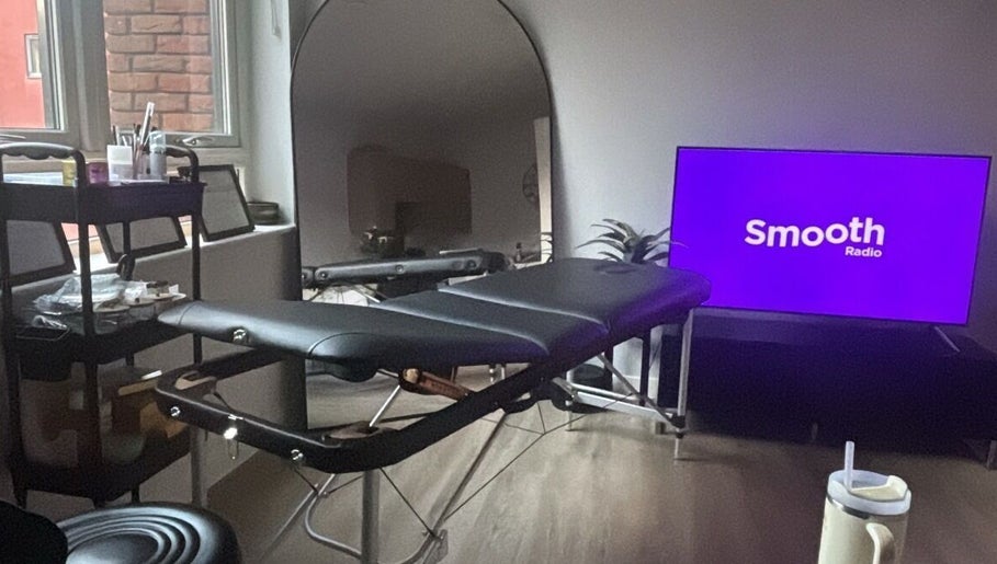 Relaxing treatment room setup at Brow & Glow Beauty, Hemel Hempstead, England, GB with a massage table and supplies.