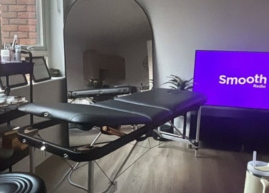 Relaxing treatment room setup at Brow & Glow Beauty, Hemel Hempstead, England, GB with a massage table and supplies.