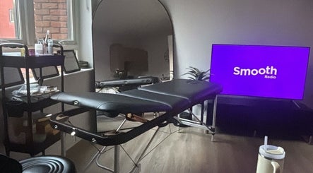 Relaxing treatment room setup at Brow & Glow Beauty, Hemel Hempstead, England, GB with a massage table and supplies.