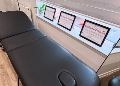 Treatment room at Brow & Glow Beauty, Hemel Hempstead, England, GB with a comfortable black massage table.