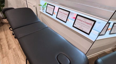 Treatment room at Brow & Glow Beauty, Hemel Hempstead, England, GB with a comfortable black massage table.
