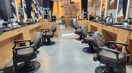Modern seating area at Slon Street salon, Abu Dhabi, AE, featuring stylish mirrors and plush chairs.