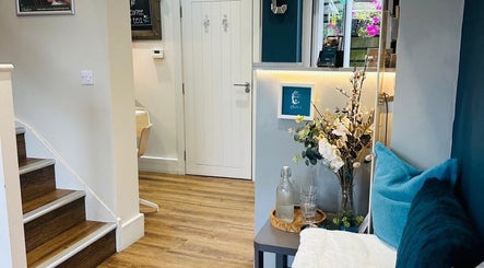 Cozy entrance of Chakra Health and Beauty Clinic in Plymouth, England, GB with inviting decor and seating.