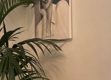 Relaxing corner with palm leaves and wall art at Chakra Advanced Therapies, Plymouth, England, GB.