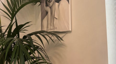 Relaxing corner with palm leaves and wall art at Chakra Advanced Therapies, Plymouth, England, GB.