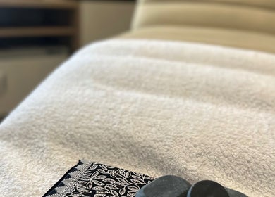 Luxurious therapy bed with stones at Chakra Advanced Therapies, Plymouth, England, GB.