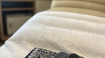 Luxurious therapy bed with stones at Chakra Advanced Therapies, Plymouth, England, GB.