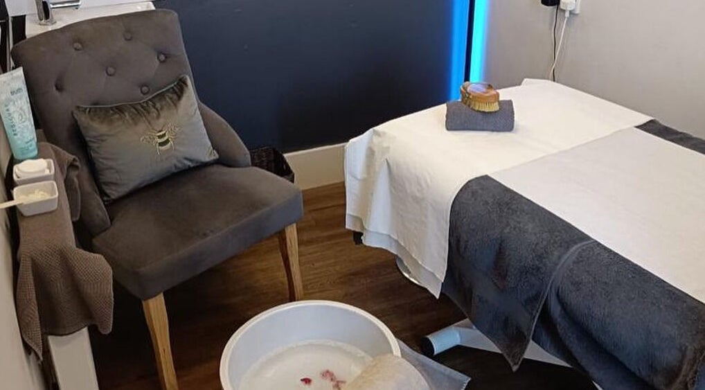 Relaxing therapy room at Chakra Health and Beauty Clinic, Plymouth, England, GB featuring cozy chair and treatment bed.