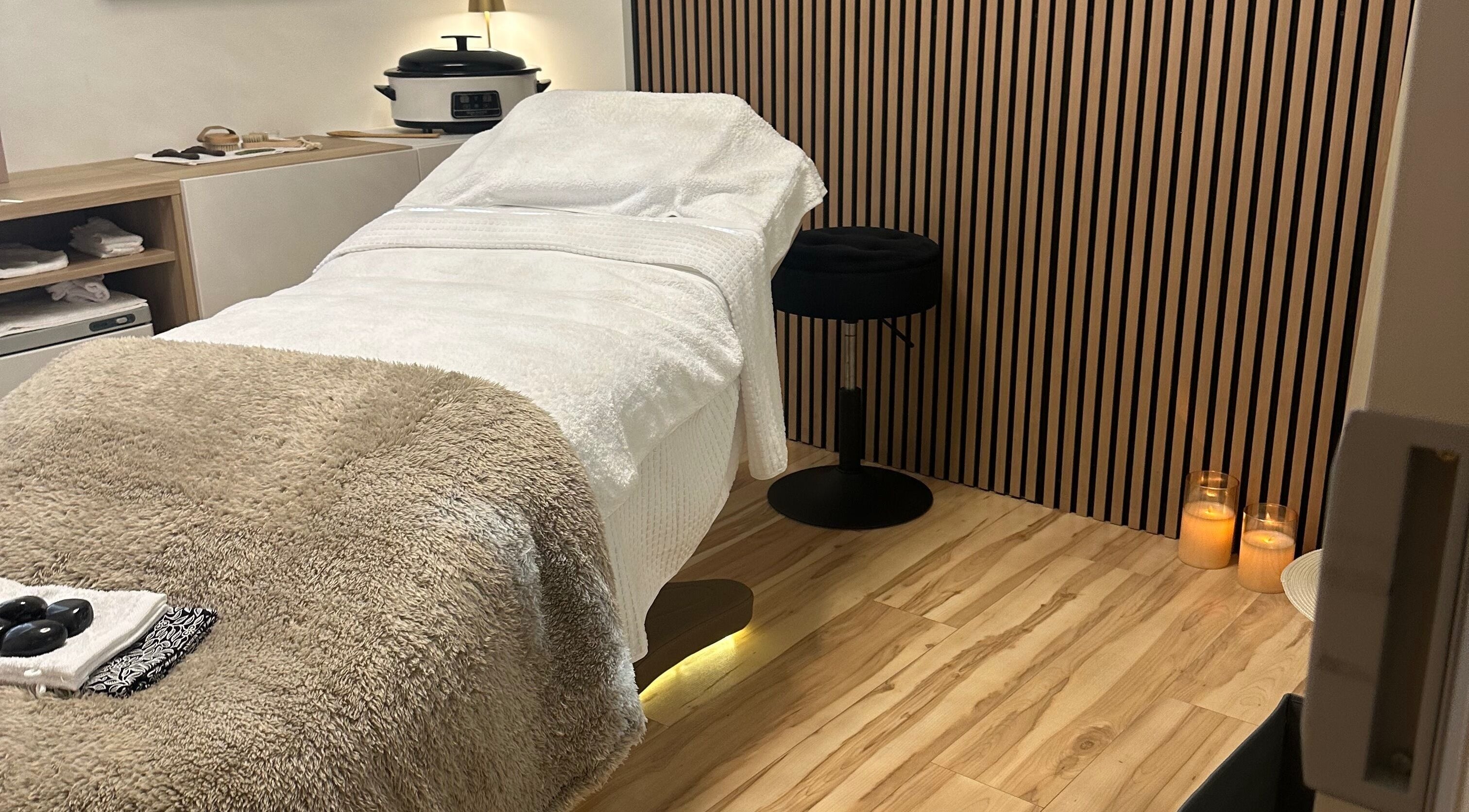 Relaxing therapy room at Chakra Advanced Therapies in Plymouth, England, GB featuring a cozy massage table.