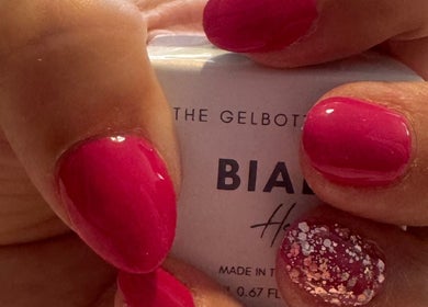 Vibrant red nails with glitter from Polished Nails & Beauty in Worcester, England, GB.