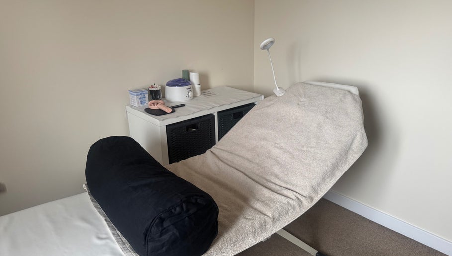 Cozy treatment room at Polished Nails & Beauty, Worcester, GB, featuring a comfortable massage bed.
