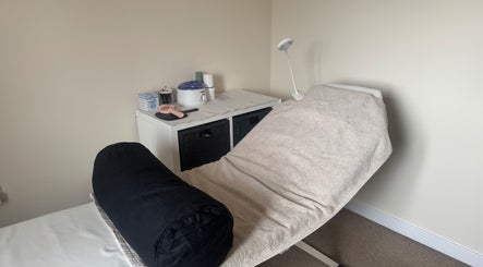 Cozy treatment room at Polished Nails & Beauty, Worcester, GB, featuring a comfortable massage bed.