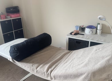 Treatment room at Polished Nails & Beauty, Worcester, GB with a comfortable massage bed and soothing decor.