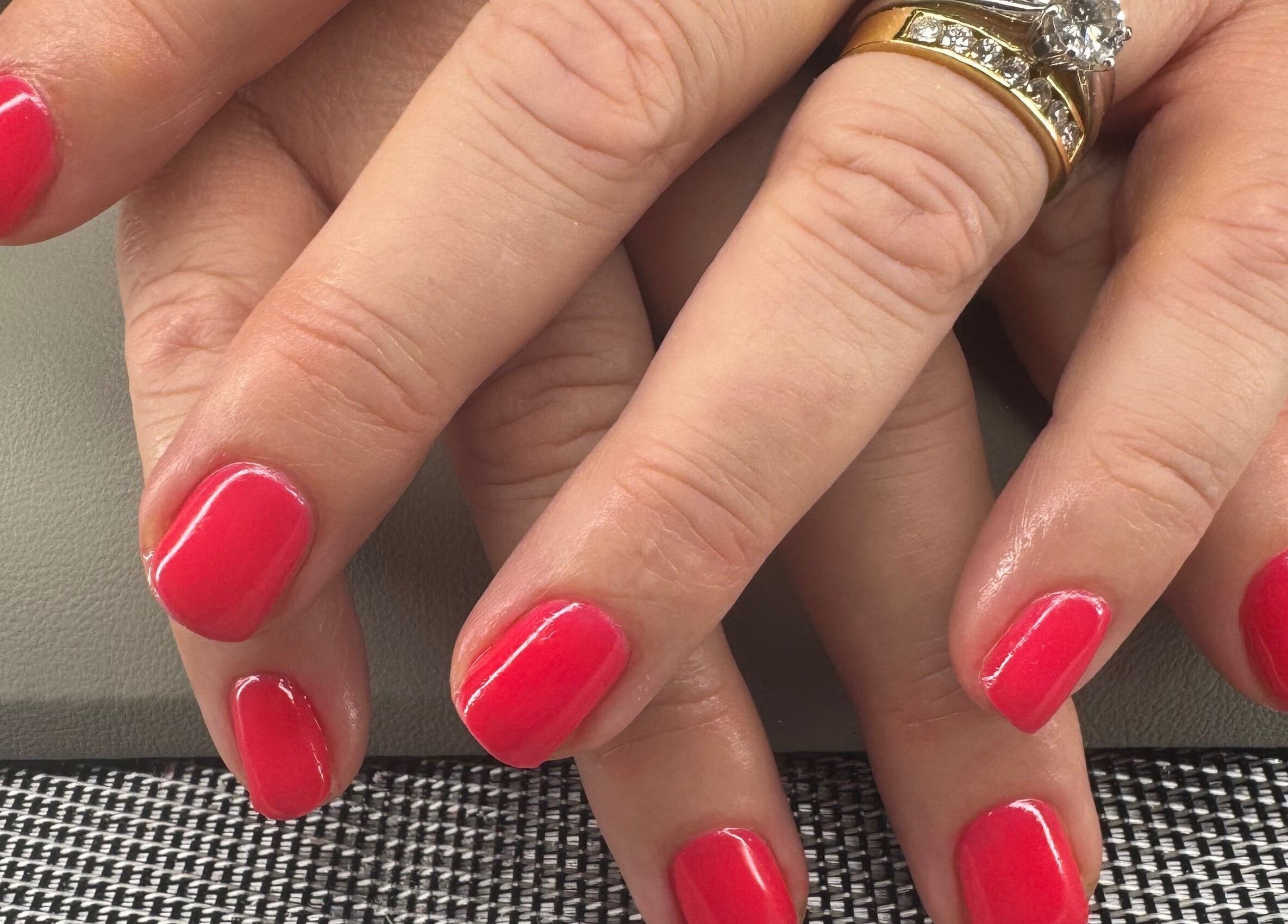 Bright red manicured nails at Polished Nails & Beauty, Worcester, GB, showcasing elegant nail design.