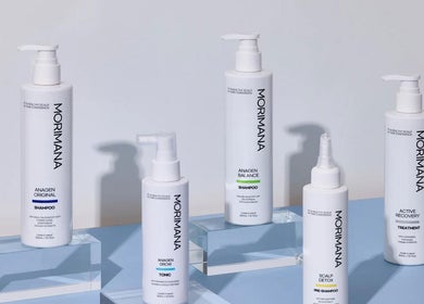 MMSTUDIO | Morimana Studio hair care products displayed on a blue surface in London, England, GB.