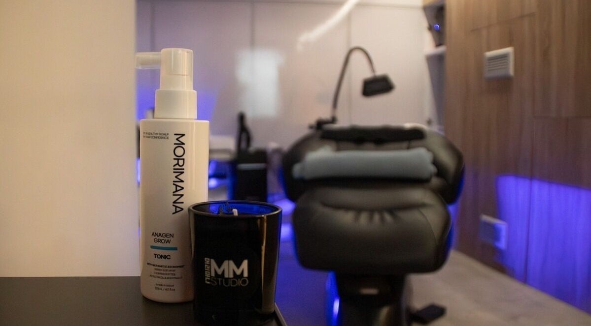 Elegant spa room at MMSTUDIO | Korean Biotech Face & Scalp Programs in London, England, GB with products displayed.