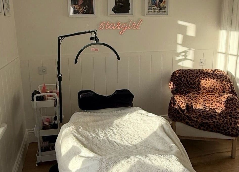 Cozy treatment room at Beauty By Mimz, Ludgvan, England, with a treatment bed and leopard print chair.