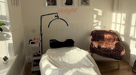 Cozy treatment room at Beauty By Mimz, Ludgvan, England, with a treatment bed and leopard print chair.