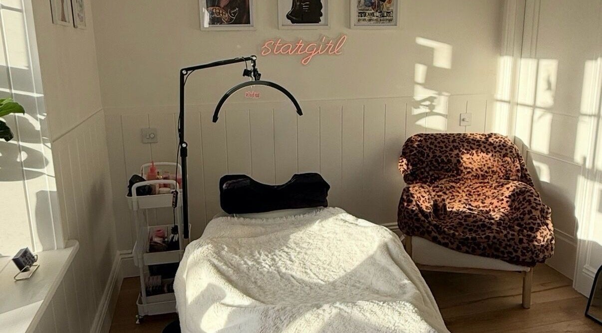 Cozy treatment room at Beauty By Mimz, Ludgvan, England, with a treatment bed and leopard print chair.