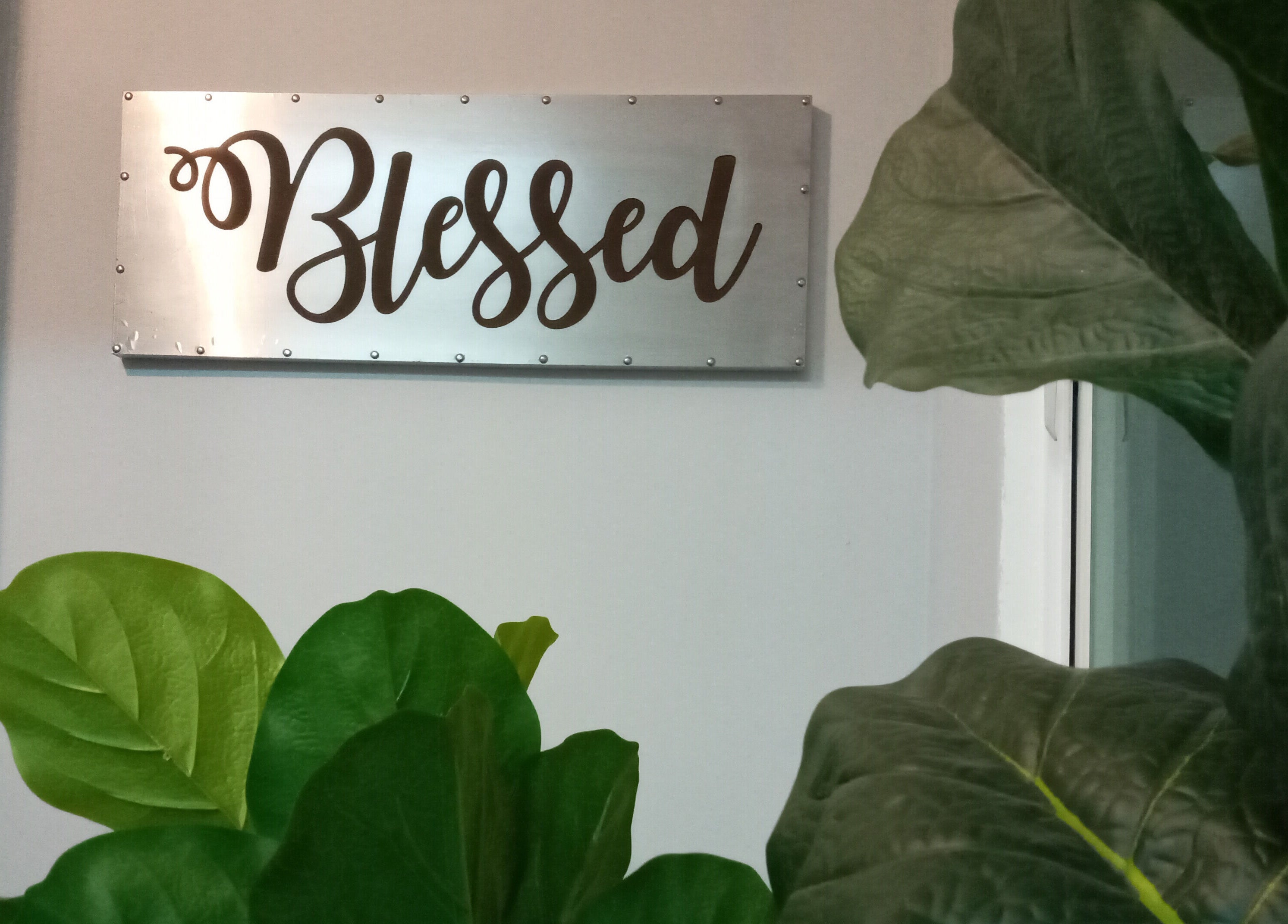 Elegant 'Blessed' sign with lush greenery at Family First Consultancy, Petaling Jaya, Selangor, MY.