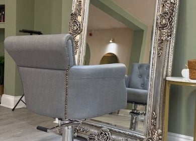 Elegant styling chair and ornate mirror at Odd Apple Salon, Langley Moor, England, GB.