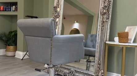 Elegant styling chair and ornate mirror at Odd Apple Salon, Langley Moor, England, GB.