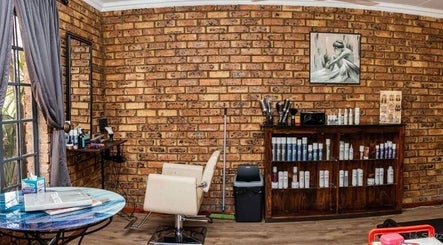 Cozy salon interior at Hair@Lerina in Centurion, Gauteng, ZA with brick walls and stylish seating.