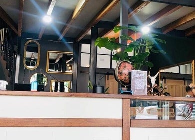 Chic interior of Mike Hairstylist / Barber in Sandton, Gauteng, ZA showcasing modern decor and mirrors.